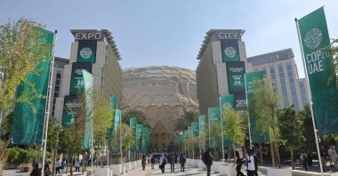 People walk at the venue of the COP28 United Nations climate summit in Dubai, United Arab Emirates, Dec. 6, 2023. (AFP Photo)