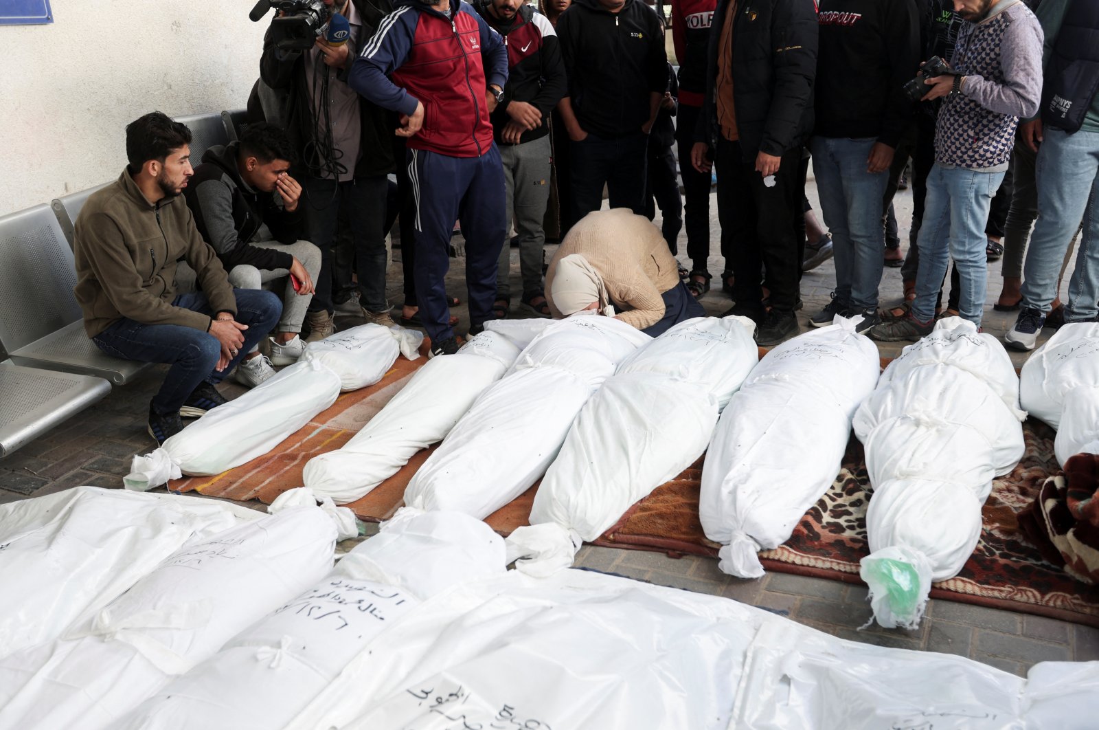People mourn near the bodies of Palestinians killed in Israeli strikes on houses, at Abu Yousef al-Najjar hospital in Rafah in the southern Gaza Strip, Palestine, Dec. 7, 2023. (Reuters Photo)