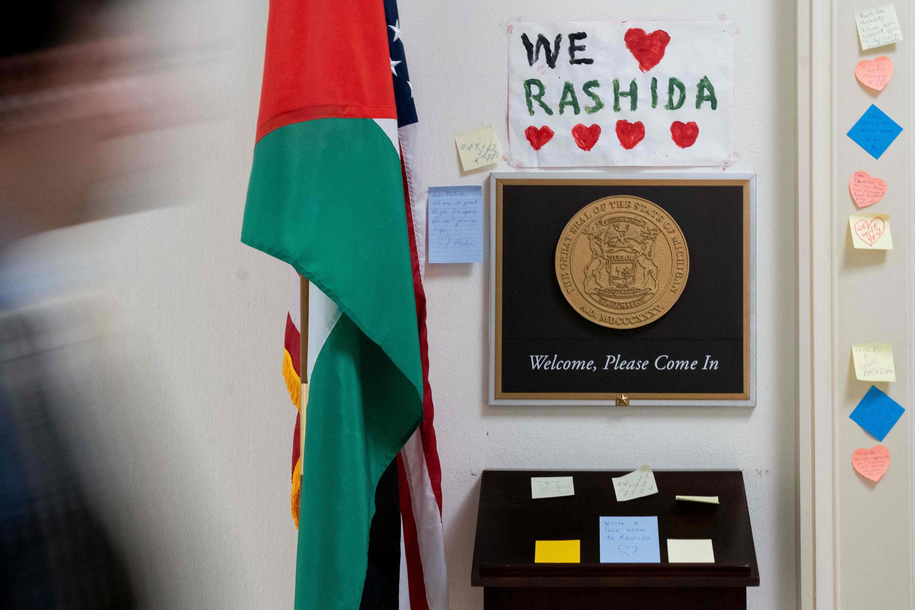 A person walks past signs and notes left outside the office of U.S. Rep. Rashida Tlaib, Democrat of Michigan, on Capitol Hill in Washington, D.C., Nov. 8, 2023. (AFP Photo)