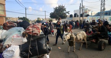 Palestinians ride donkey-pulled carts as they flee toward safer areas following the resumption of Israeli strikes on Rafah, Gaza Strip, Palestine, Dec. 1, 2023. (AFP Photo)