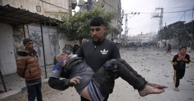 A Palestinian man evacuates a wounded boy following Israeli airstrikes in Khan Younis refugee camp, southern Gaza Strip, Dec. 7, 2023. (AP Photo)