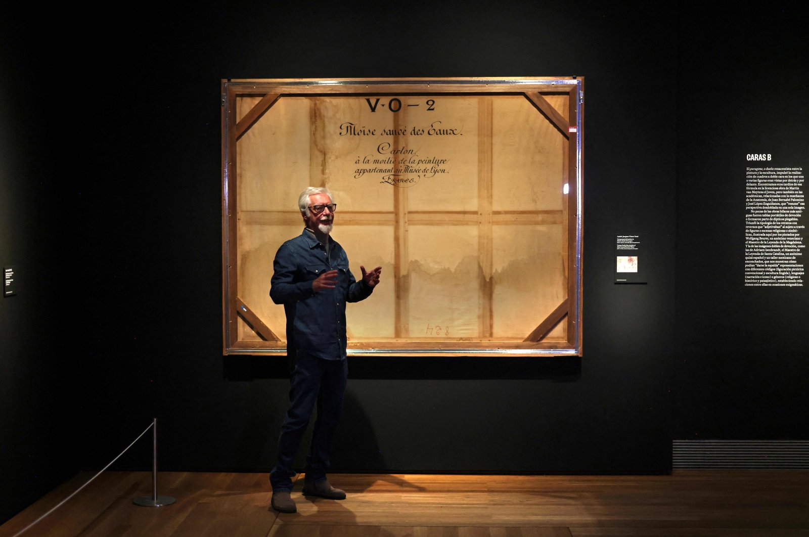 Miguel Angel Blanco, exhibition curator, gives some explanations about the back side of a painting called "Trompe l&#039;oeil of the stretcher of Moses rescued from the Waters" by French artist Victor Orsel at the Prado Museum in Madrid, Spain, Dec. 5, 2023. (AFP Photo)