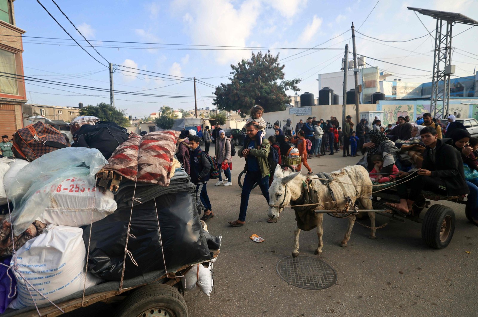 Palestinians ride donkey-pulled carts as they flee toward safer areas following the resumption of Israeli strikes on Rafah, Gaza Strip, Palestine, Dec. 1, 2023. (AFP Photo)