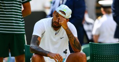 Australia's Nick Kyrgios looks in pain with a shoulder injury during his match against Brandon Nakashama of the United States during day eight of The Championships Wimbledon 2022 at All England Lawn Tennis and Croquet Club, London, UK., July 4, 2022. (Getty Images Photo)