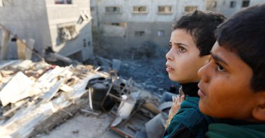 Palestinian children look at the damage at the site of Israeli strikes on houses in Khan Younis, southern Gaza Strip, Palestine, Dec. 10, 2023. (Reuters Photo)