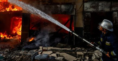 A Palestinian firefighter works to extinguish a fire in a house after an Israeli strike in Khan Younis, southern Gaza Strip, Palestine, Dec. 9, 2023. (Reuters Photo)