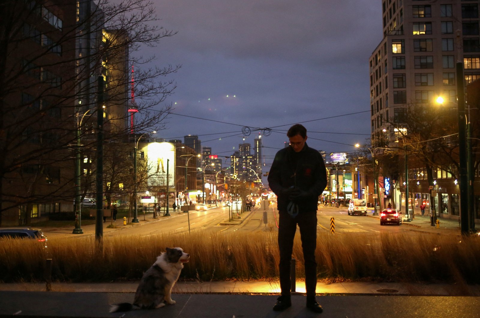Justinas Stankus, 38, who came to Canada from Lithuania in 2019 and is studying at the University of Toronto, walks his dog in Toronto, Ontario, Canada, Nov. 29, 2023. (Reuters Photo)