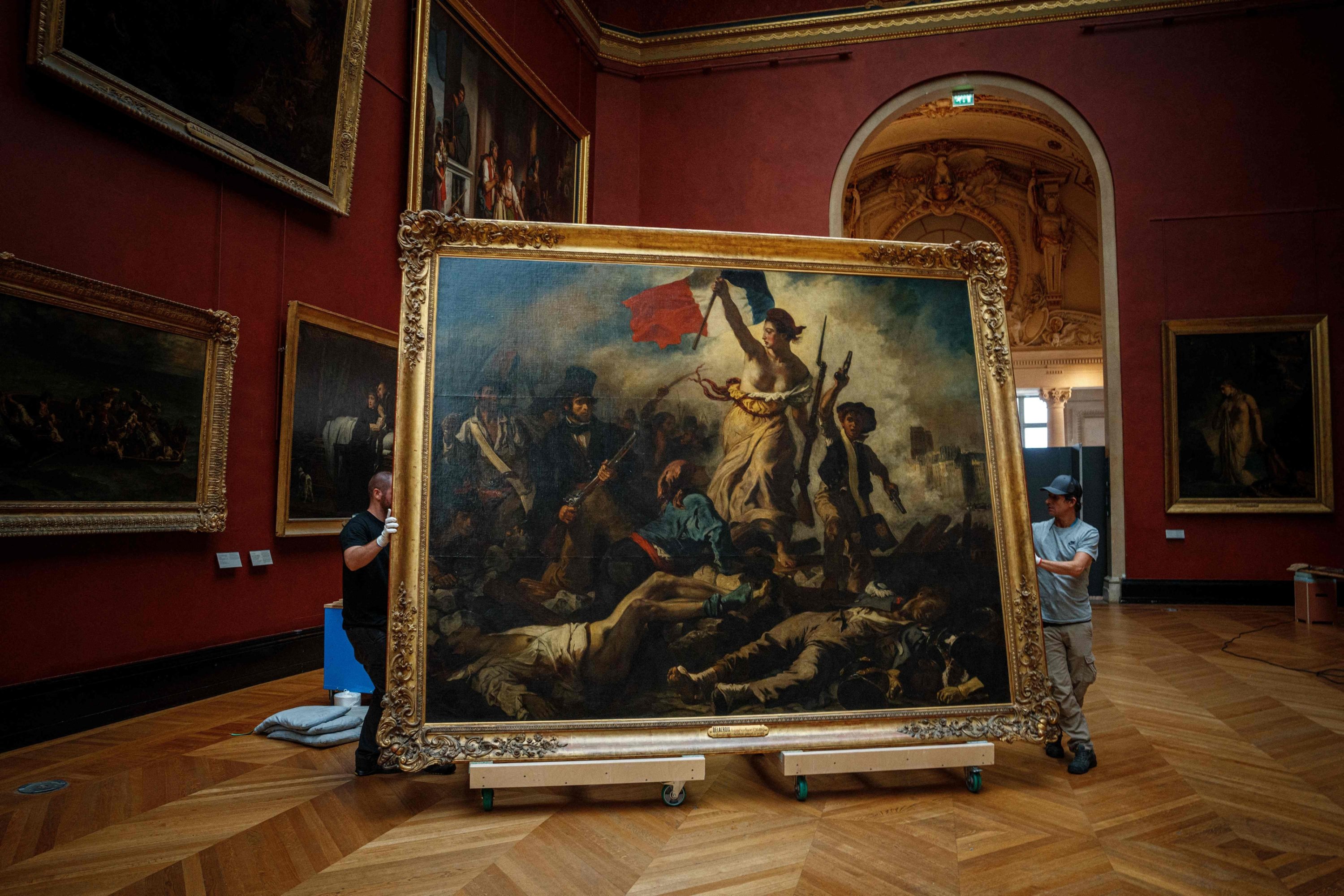 Gallery workers remove the painting 