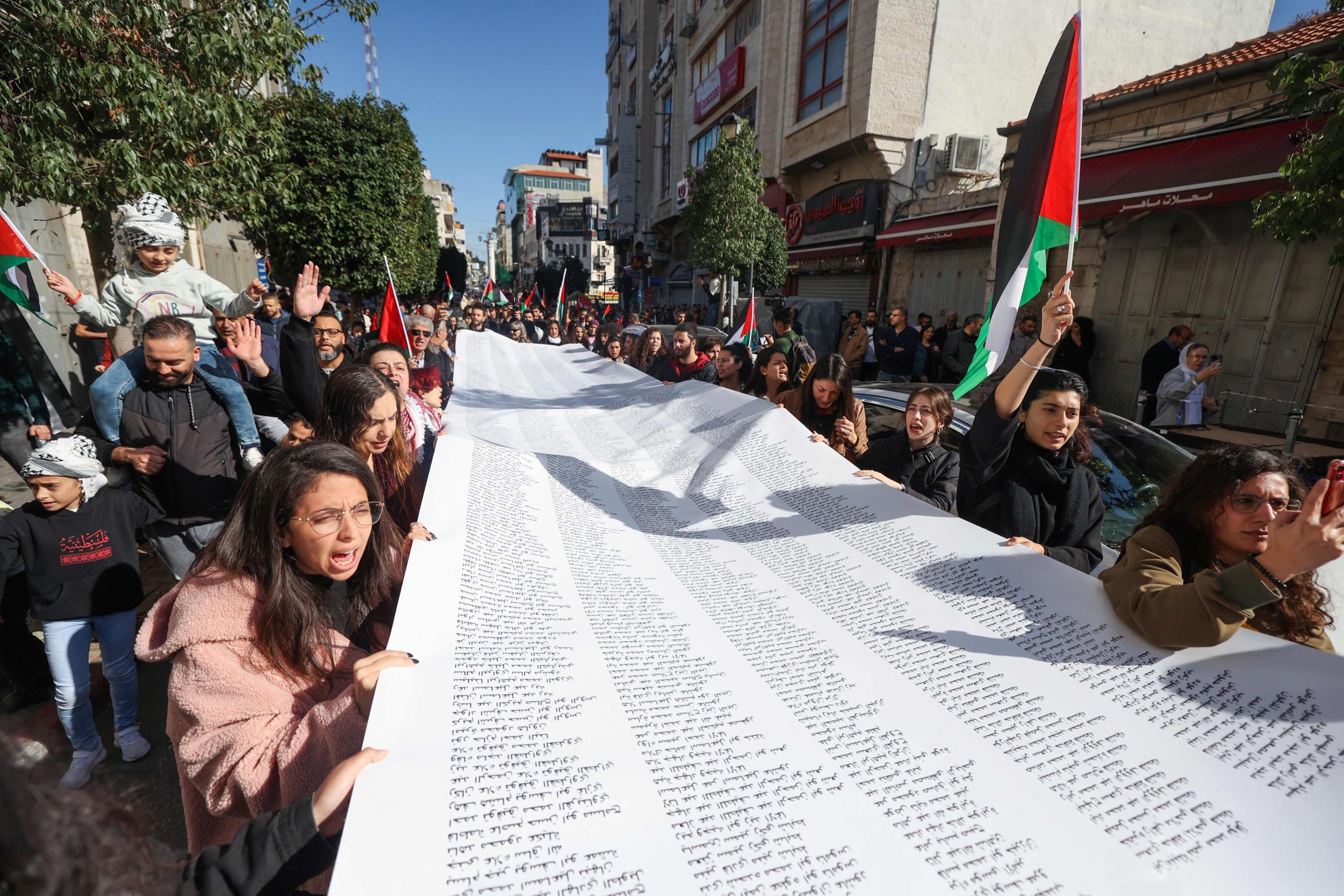 Palestinians carry a list of Gaza victims during a rally amid a general strike, Ramallah, occupied West Bank, Palestine, Dec. 11, 2023. (AFP Photo)