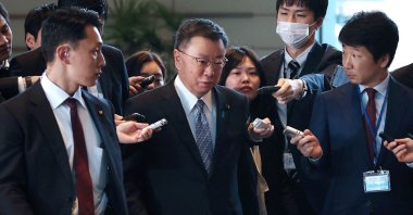 Japan's Chief Cabinet Secretary Hirokazu Matsuno (C) is surrounded by reporters in Tokyo, Japan, Dec. 11, 2023. (AFP Photo)