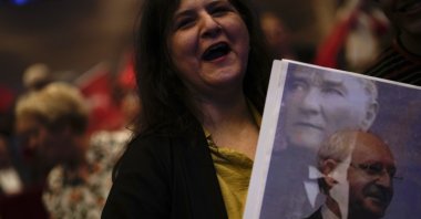 A supporter of the former Republican People’s Party (CHP) chair Kemal Kılıçdaroğlu holds a picture of him as she attends an election campaign meeting in Istanbul, Türkiye, May 26, 2023. (AP Photo)