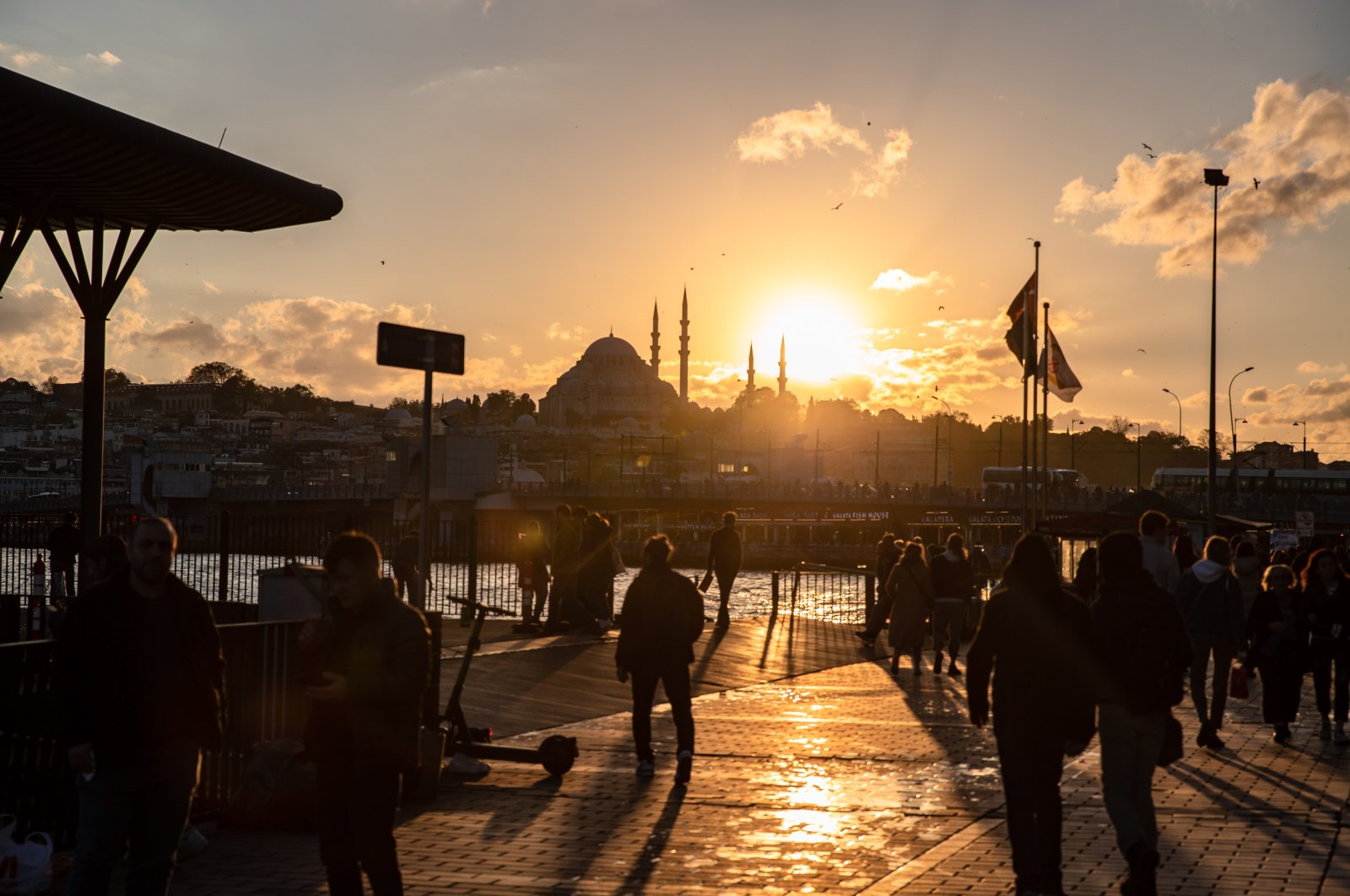 People are seen walking around the Karaköy pier during sunset in Istanbul, Türkiye, Nov. 9, 2023. (Reuters Photo)