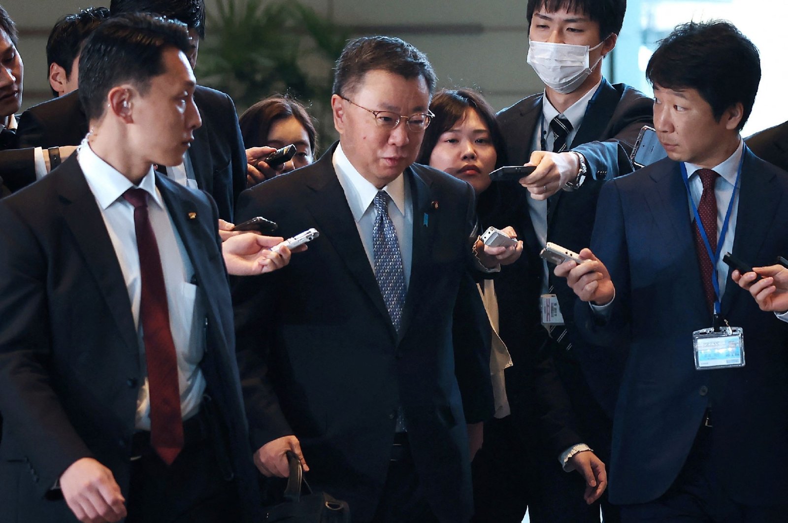 Japan&#039;s Chief Cabinet Secretary Hirokazu Matsuno (C) is surrounded by reporters in Tokyo, Japan, Dec. 11, 2023. (AFP Photo)