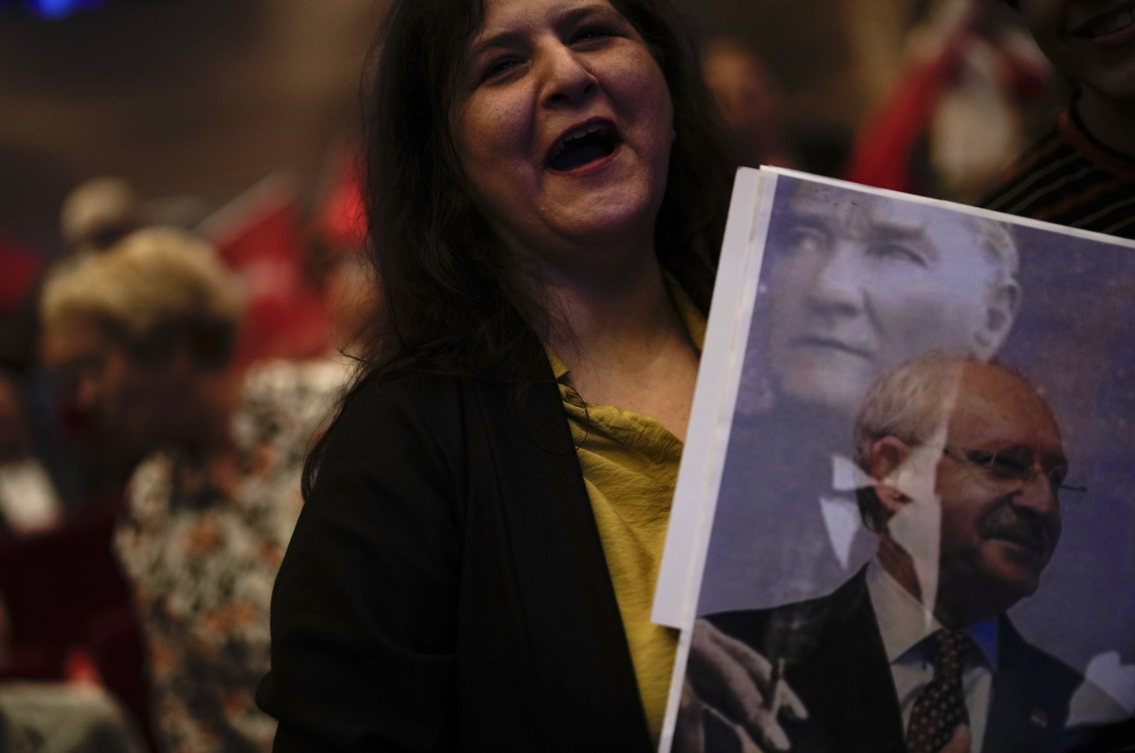 A supporter of the former Republican People’s Party (CHP) chair Kemal Kılıçdaroğlu holds a picture of him as she attends an election campaign meeting in Istanbul, Türkiye, May 26, 2023. (AP Photo)