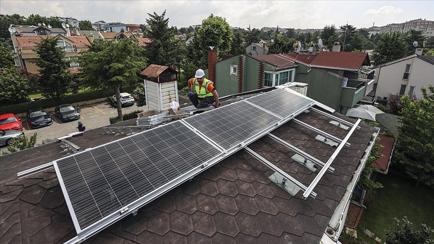 A worker is seen installing solar panels on a rooftop at an undisclosed location, Dec. 11, 2023. (AA Photo)