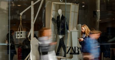 People walk past a Zara shop window at Passeig de Gracia in Barcelona, Spain, Dec. 11, 2023. (Reuters Photo)