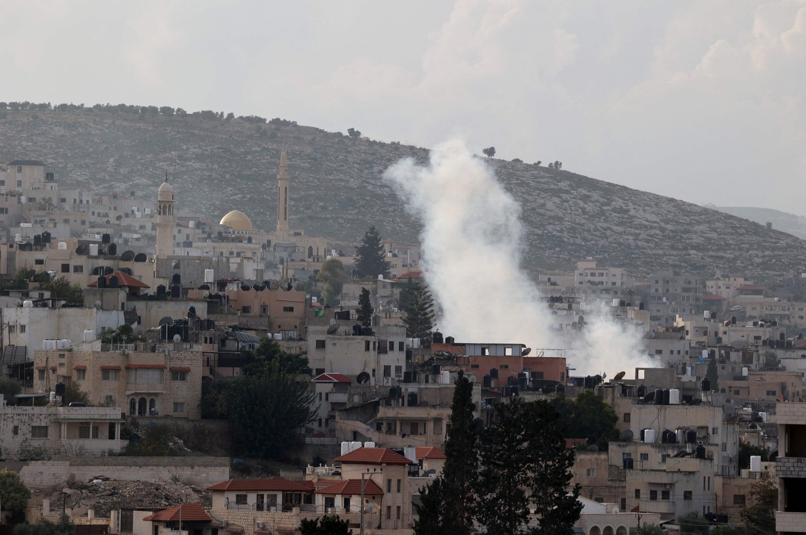 Smoke billows in the Jenin refugee camp in the occupied West Bank during a raid by the Israeli army, Palestine, Dec. 12, 2023. (AFP Photo)