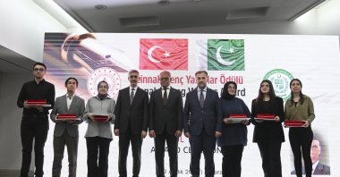 Awards are presented to the winning students by Pakistan's Ambassador to Ankara, Yusuf Cüneyd (C), Ankara, Türkiye, Dec. 12, 2023. (AA Photo)