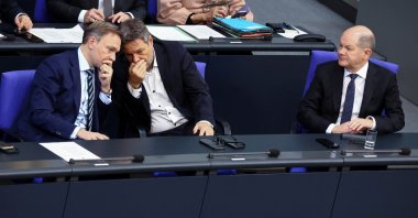 German Chancellor Olaf Scholz looks on as German Finance Minister Christian Lindner speaks with German Economy and Climate Minister Robert Habeck on the day of delivering a government declaration on the budget situation to the Bundestag, Berlin, Germany, Nov. 28, 2023. (Reuters Photo)