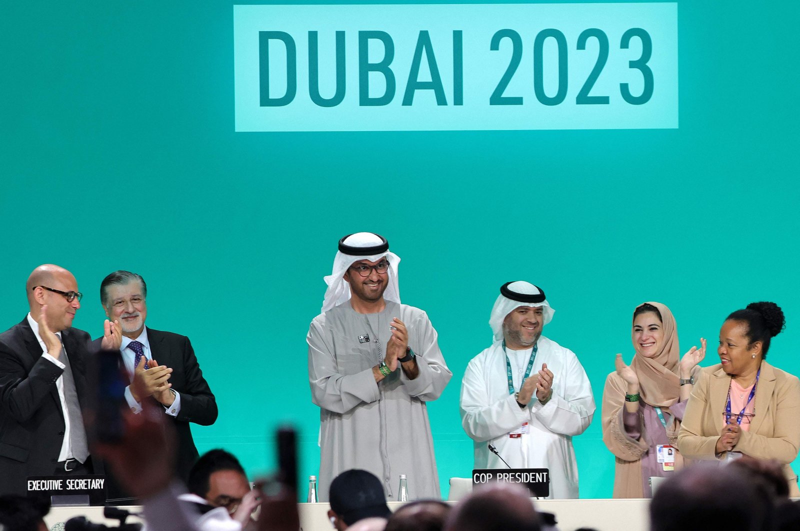 COP28 President Sultan Ahmed Al Jaber (C) applauds among other officials before a plenary session during the United Nations climate summit in Dubai, United Arab Emirates, Dec. 13, 2023. (AFP Photo)