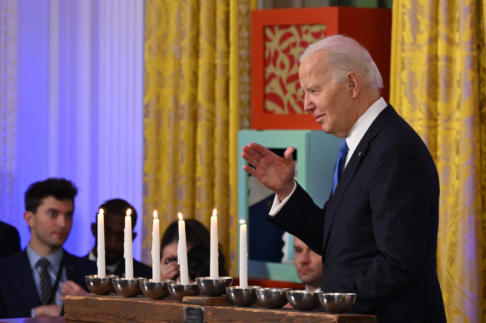 U.S. President Joe Biden waves as he walks by the Menorah during a Hanukkah reception in the White House, Washington, D.C., Dec. 11, 2023. (AFP Photo)