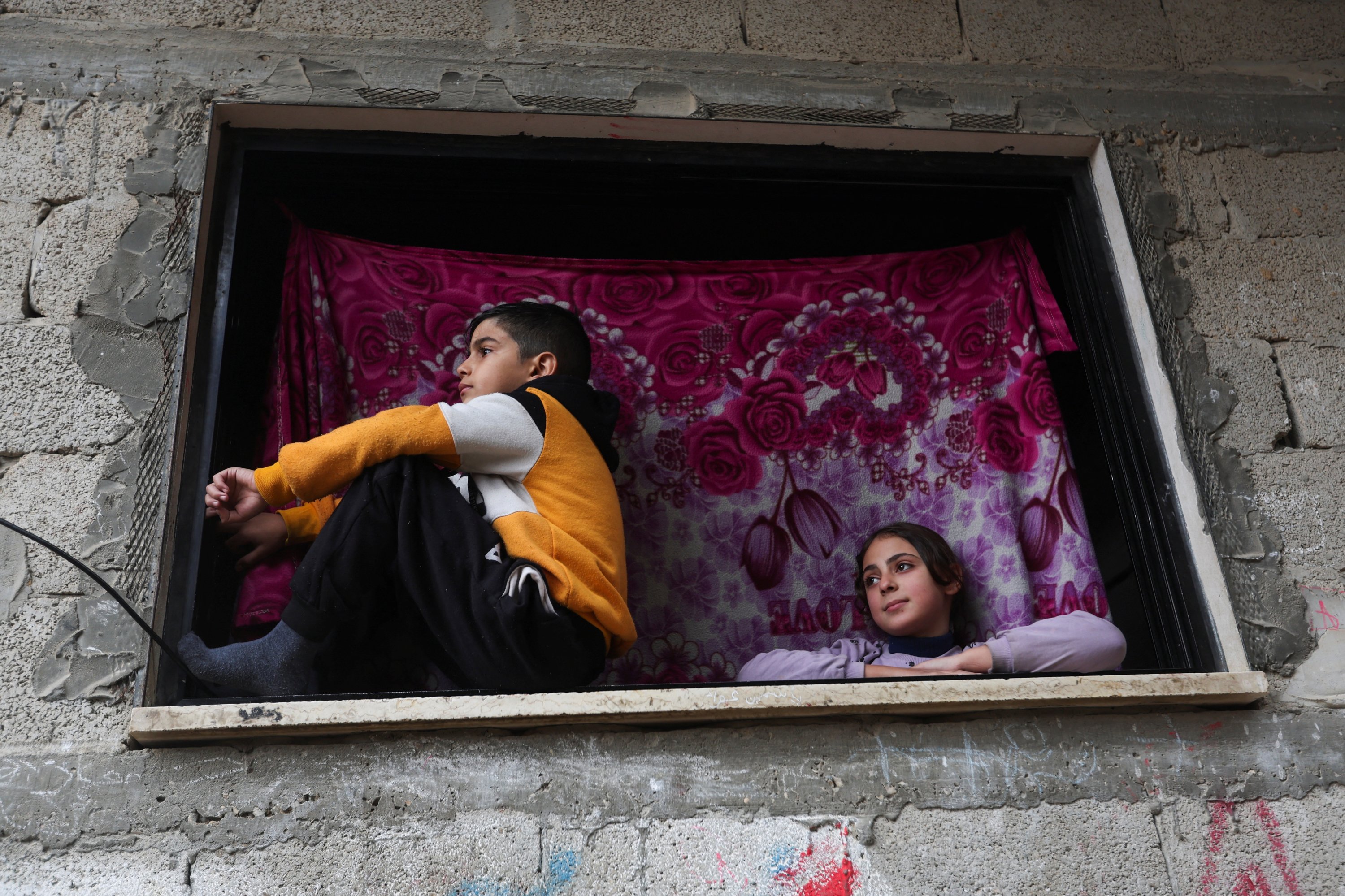 Palestinian children look on from a window in Khan Younis, southern Gaza Strip, Palestine, Dec. 13, 2023. (Reuters Photo)