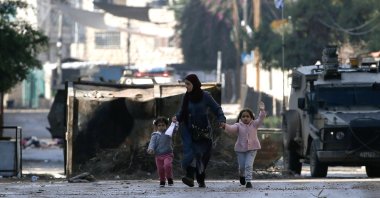 A Palestinian mother and her children flee the Jenin refugee camp in search of a safer space amid an Israeli raid, occupied West Bank, Palestine, Dec. 14, 2023. (EPA Photo)