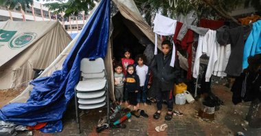 Palestinians children pose in front of their makeshift tent at a camp in Rafah, southern Gaza Strip, Palestine, Dec. 13, 2023. (AFP Photo)