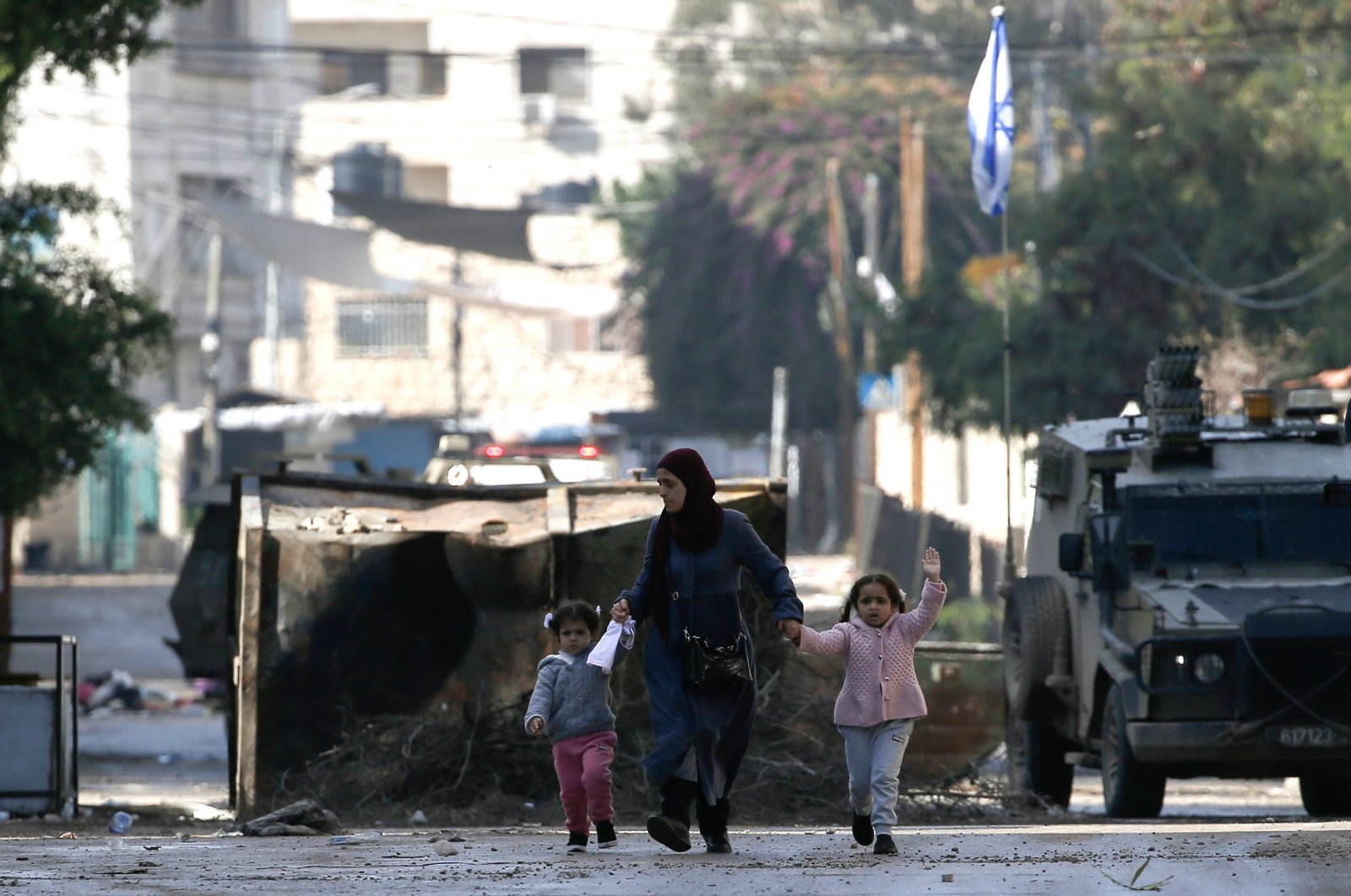 A Palestinian mother and her children flee the Jenin refugee camp in search of a safer space amid an Israeli raid, occupied West Bank, Palestine, Dec. 14, 2023. (EPA Photo)