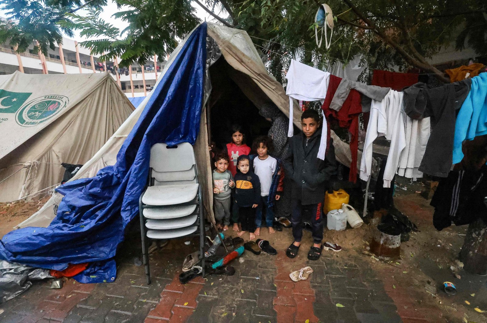 Palestinians children pose in front of their makeshift tent at a camp in Rafah, southern Gaza Strip, Palestine, Dec. 13, 2023. (AFP Photo)