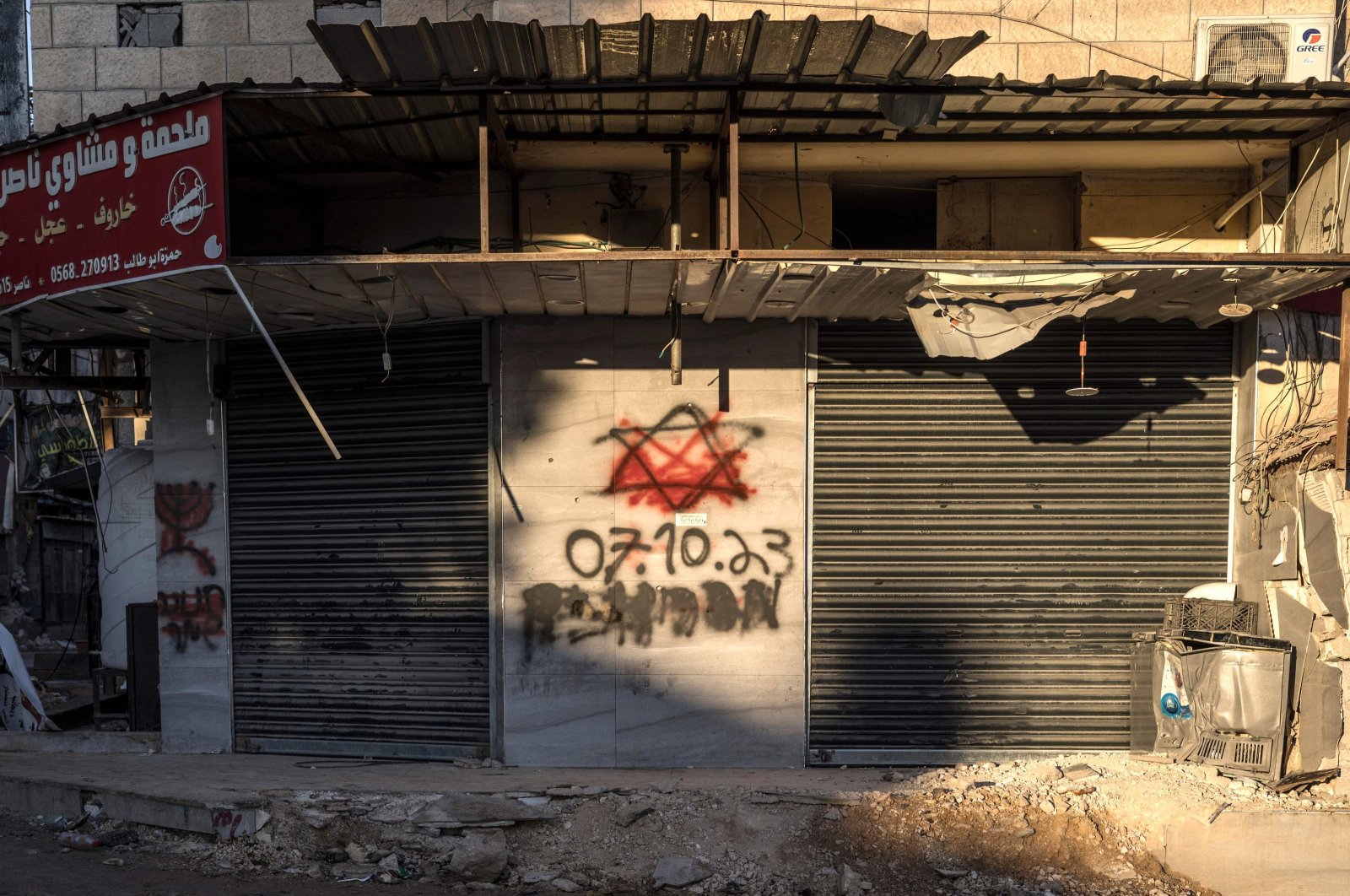 Red paint covers a Star of David with the date of Oct. 7, 2023 sprayed by Israeli soldiers on a wall in the Jenin refugee camp, occupied West Bank, Dec. 15, 2023. (AFP Photo)