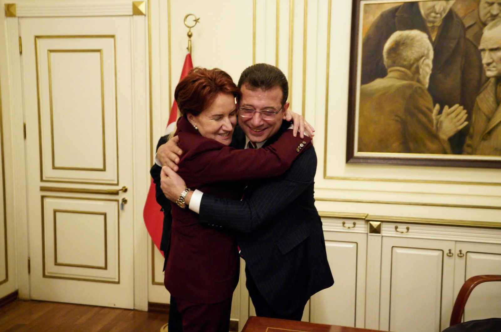 Good Party (IP) Chair Meral Akşener (L) embraces Istanbul Mayor Ekrem Imamoğlu after the latter is convicted of insulting a public official at the mayoral building in Istanbul, Türkiye, Dec. 15, 2022. (DHA Photo)