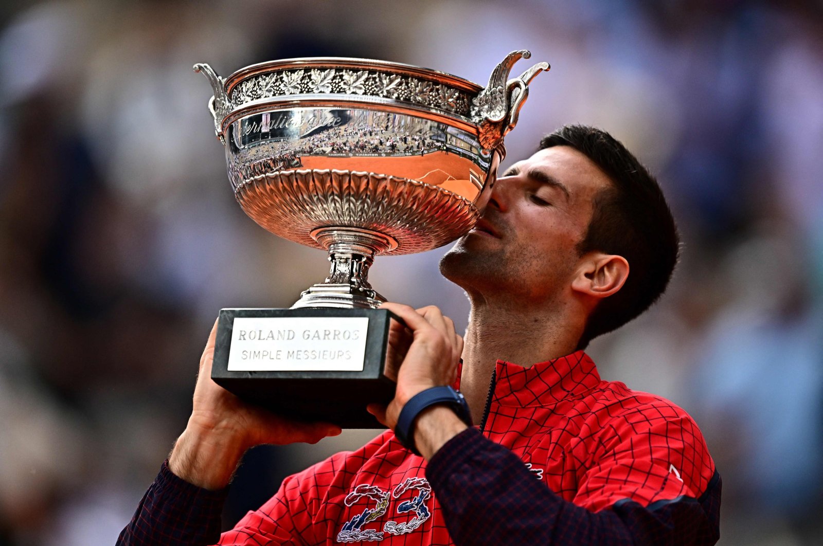 Serbia&#039;s Novak Djokovic kisses his trophy as he celebrates his victory over Norway&#039;s Casper Ruud during their men&#039;s singles final match on Day 15 of the Roland-Garros Open tennis tournament at the Court Philippe-Chatrier, Paris, France, June 11, 2023. (AFP Photo)