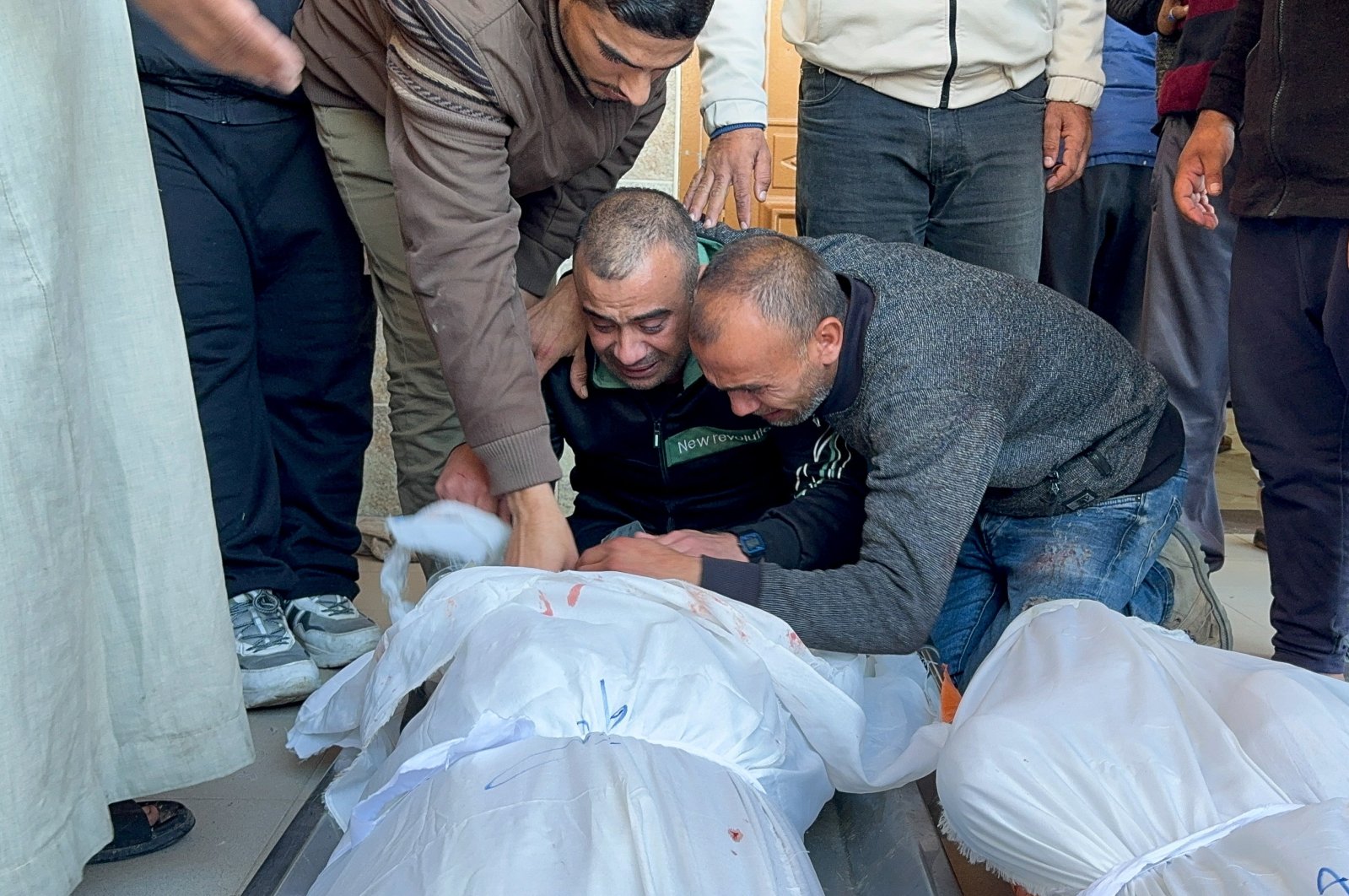 Mourners react next to the bodies of Palestinians killed in Israeli strikes, Khan Younis, southern Gaza Strip, Palestine, Dec. 15, 2023. (Reuters Photo)