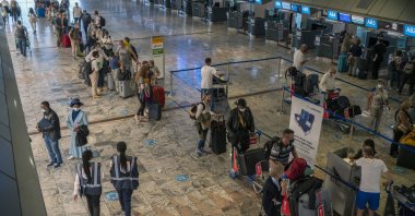 Passengers check in at a counter at Johannesburg&#039;s OR Tambo International Airport, South Africa, Nov. 29, 2021. (AP Photo)