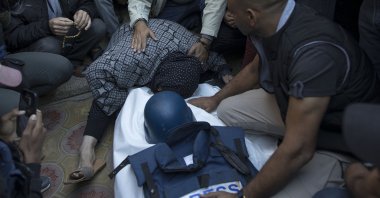 Relatives and colleagues of Palestinian journalist Samer Abu Daqqa mourn next to his wrapped body in Khan Yunis, southern Gaza Strip, Palestine, Dec. 16, 2023. (EPA Photo)