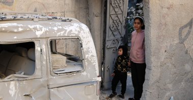 Palestinian children stare at the destruction following an early morning Israeli strike in Rafah in the southern Gaza Strip, Palestine, Dec. 9, 2023. (AFP Photo)