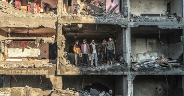 Palestinians check a half-destroyed building following Israeli bombardment on Rafah, southern Gaza Strip, Palestine, Dec. 15, 2023. (AFP Photo)