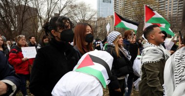 A demonstrator holds a replica of a dead Palestinian child wrapped in a burial shroud at a rally in Boston, U.S., Dec. 17, 2023. (Reuters Photo)
