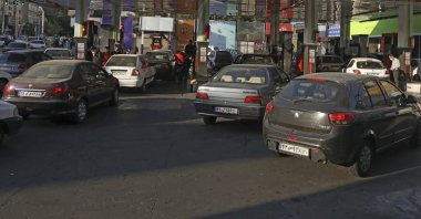 People fill their cars at a gas station in Tehran, Iran, Oct. 27, 2021. (AP Photo)