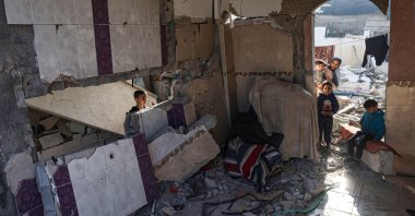 Palestinian youths are seen in the rubble of a damaged house in Rafah in the southern Gaza Strip, Palestine, Dec. 18, 2023. (AFP Photo)