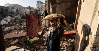 A woman carries bread in her destroyed house in Rafah, southern Gaza Strip, Palestine, Dec. 18, 2023. (AFP Photo)
