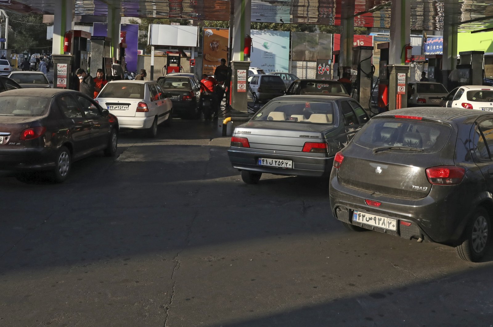 People fill their cars at a gas station in Tehran, Iran, Oct. 27, 2021. (AP Photo)