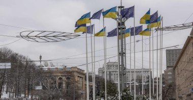 Cars drive past flags of Ukraine and the European Union on the European Square in downtown Kyiv, Ukraine, on Dec. 15, 2023. European Union leaders agreed on Dec. 14, to open formal membership negotiations with Ukraine and Moldova, despite an earlier threat from Hungary to veto the deal. (AFP Photo)