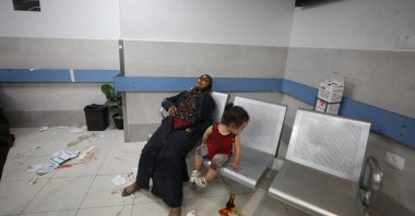 An injured mother and child rest after an Israeli airstrike hit a hospital killing 500 people, in Gaza City, Gaza Strip, Palestine, Oct. 17, 2023. (Reuters File Photo)