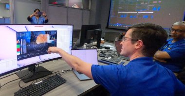 Members of the DSOC team react to the first high-definition streaming video to be sent via laser by the DSOC transceiver aboard the Psyche spacecraft, nearly 19 million miles from Earth, Pasadena, California U.S. Dec. 18, 2023. (AFP Photo)