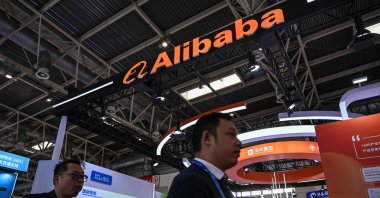 People walk past an Alibaba booth during the China International Supply Chain Expo (CISCE) in Beijing, China, Dec. 1, 2023. (AFP Photo)