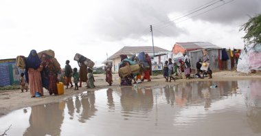 Displaced Somali vacate their camps after heavy floods entered their makeshift shelter in Mogadishu, Somalia, Nov.13, 2023. (AP Photo)