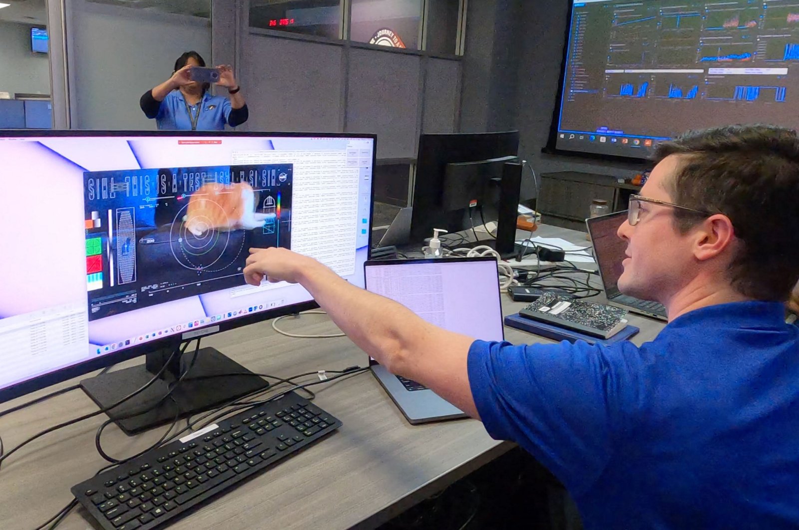 Members of the DSOC team react to the first high-definition streaming video to be sent via laser by the DSOC transceiver aboard the Psyche spacecraft, nearly 19 million miles from Earth, Pasadena, California U.S. Dec. 18, 2023. (AFP Photo)