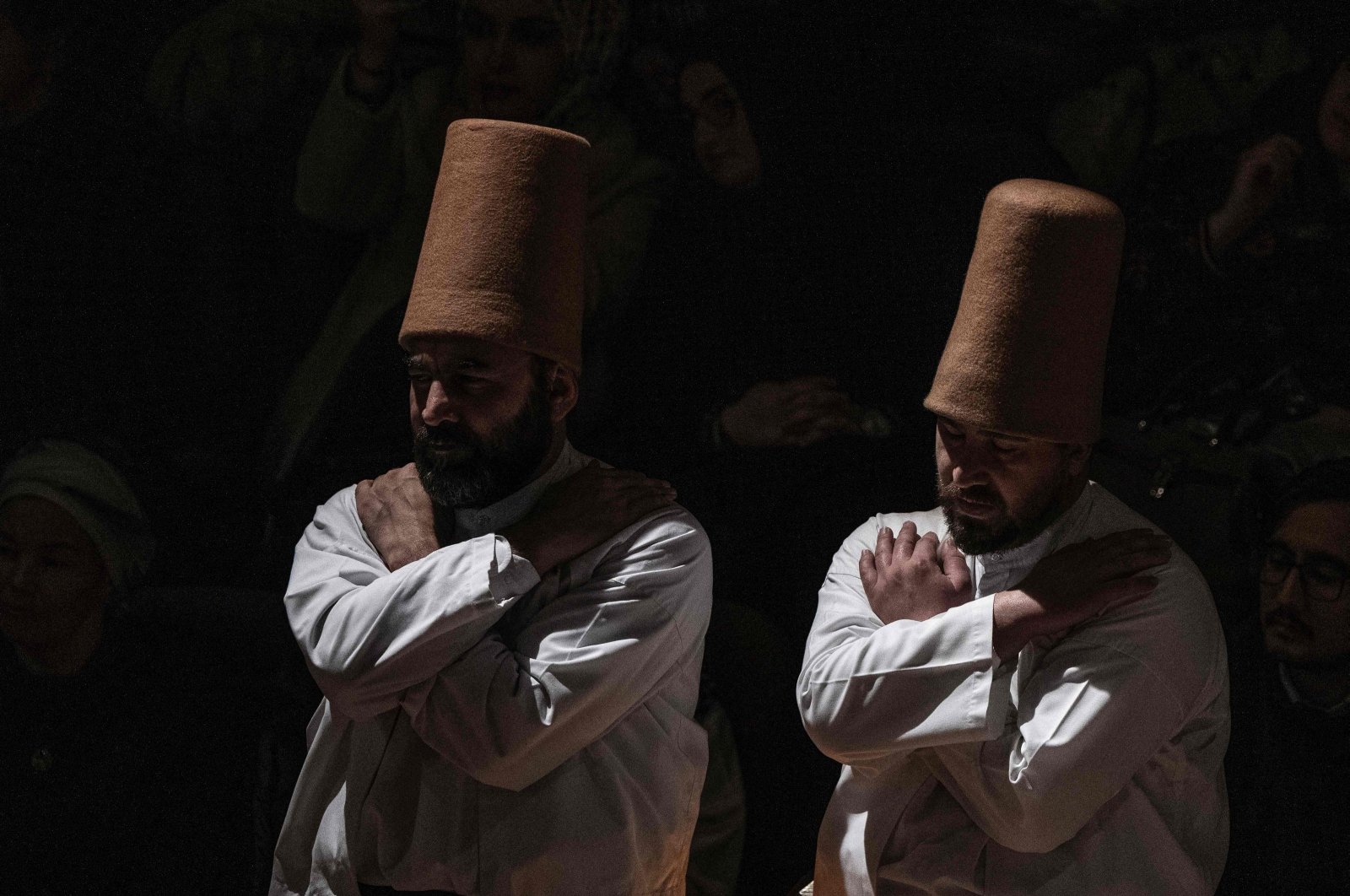 Whirling dervishes, wearing the symbolic hat &quot;sikke&quot;, perform the &quot;Sema&quot; ritual as part of a ceremony to celebrate the 750th anniversary of the death of Mevlana Jalaluddin Rumi, 13th-century Islamic poet, scholar, and Sufi mystic, at Mevlana Cultural Center in Konya, Türkiye, Dec. 17, 2023. (AFP Photo)